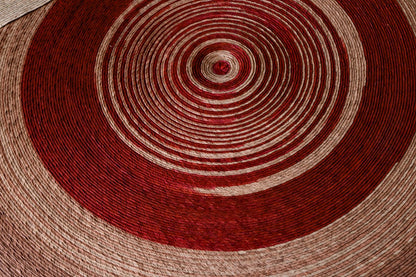 Hand-woven circular rug in natural palm fiber